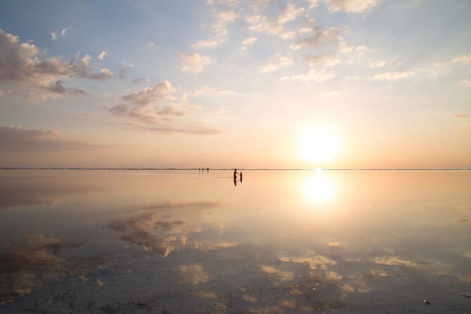 Free Image of People Walking Across Large Body of Water 