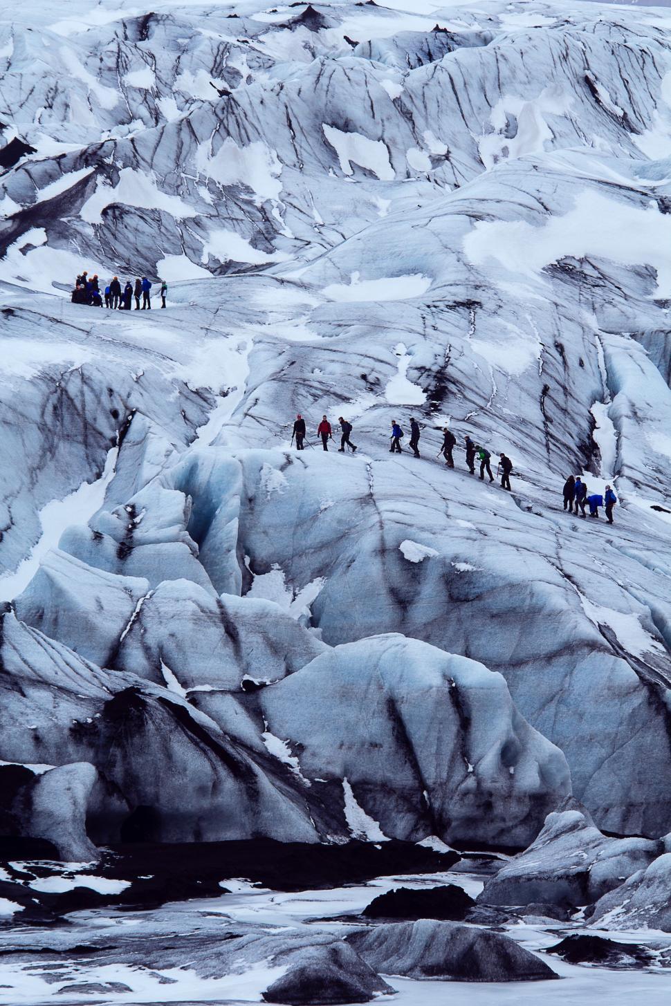Free Image of Group of People Standing on Top of Snow Covered Mountain 