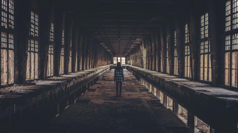 Free Image of Person Standing in Dark Room With Lots of Windows 