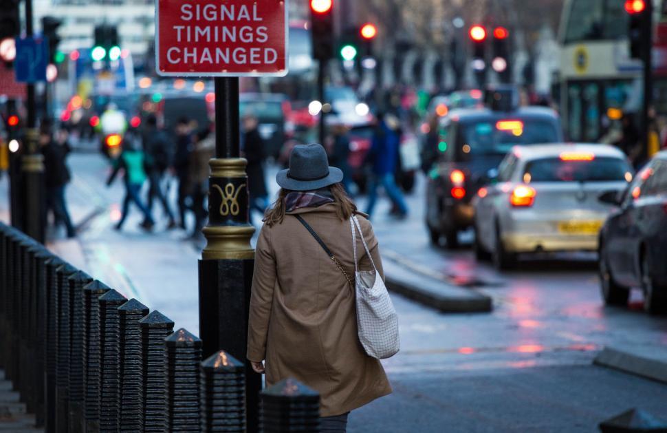 Free Image of Man Walking Next to Traffic Light 