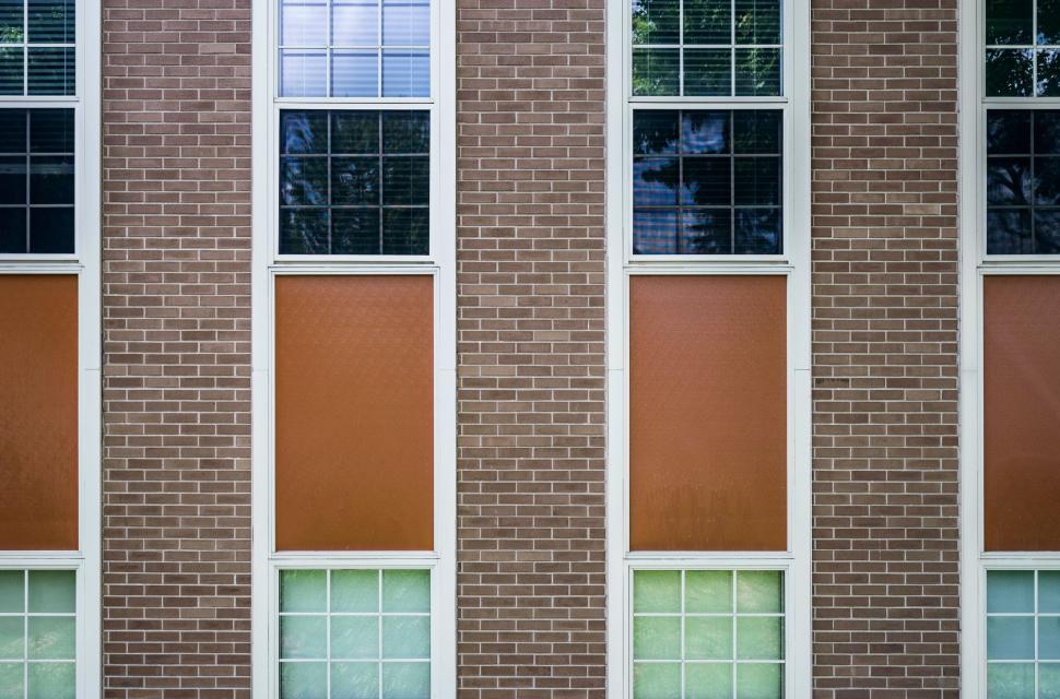 Free Image of Red Fire Hydrant in Front of Tall Brick Building 