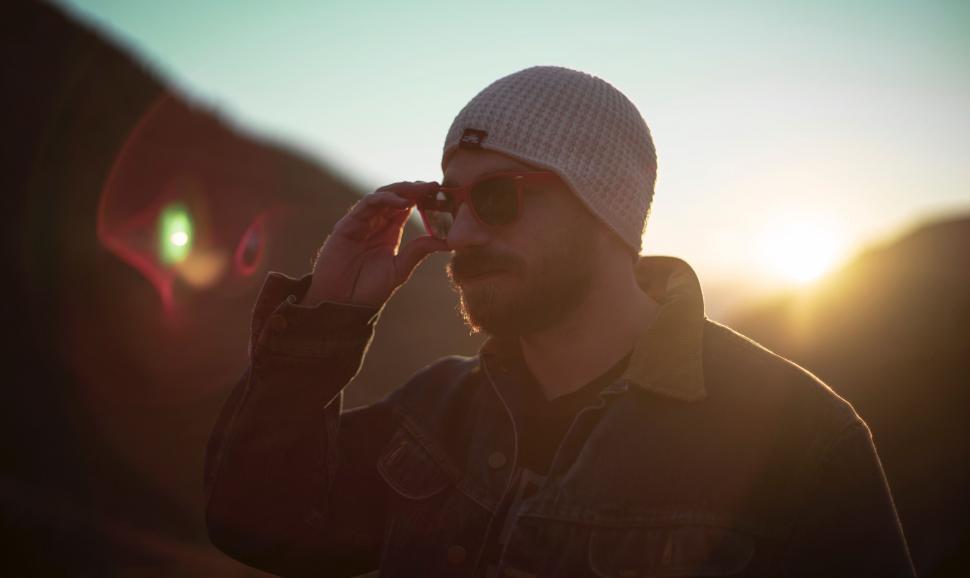 Free Image of Man in Hat and Sunglasses Talking on Cell Phone 