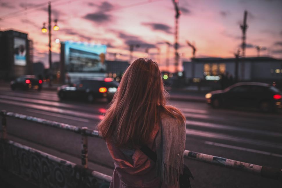 Free Image of Woman Standing on the Side of a Road 