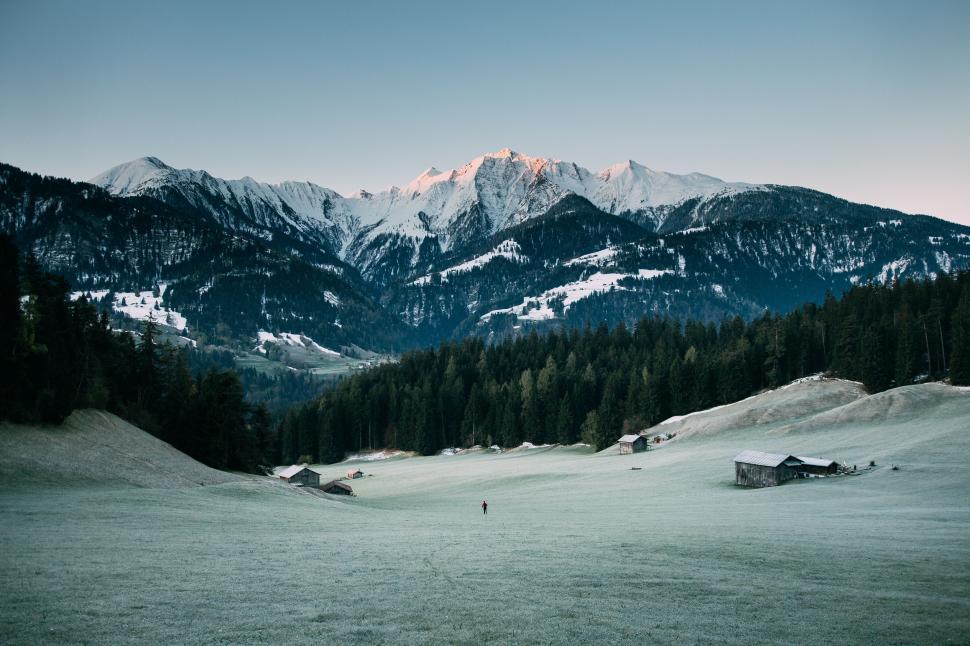 Free Image of Person Walking in Snowy Mountain Range 