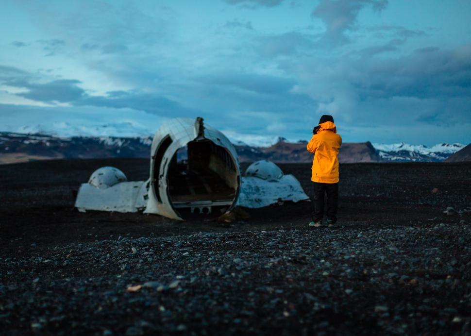 Free Image of Person in Yellow Jacket Standing Next to Car 