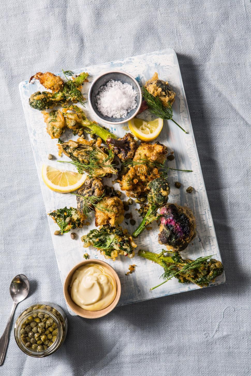 Free Image of Platter of Food With Broccoli, Lemons, and Sauces 