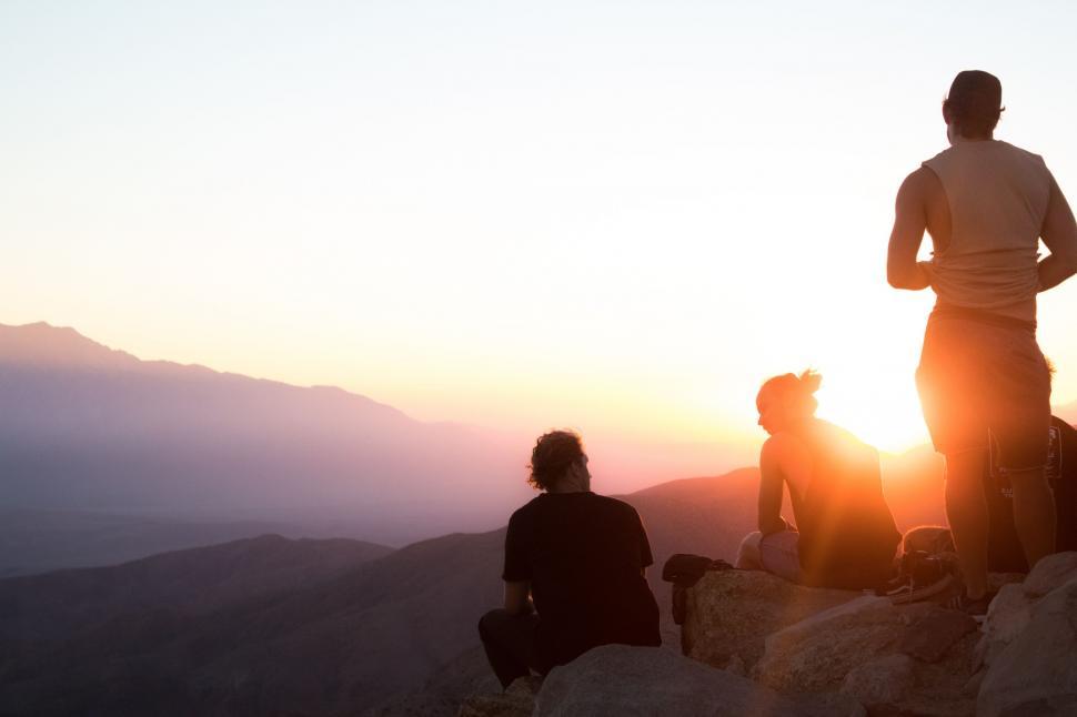 Free Image of Group of People Standing on Top of a Mountain 