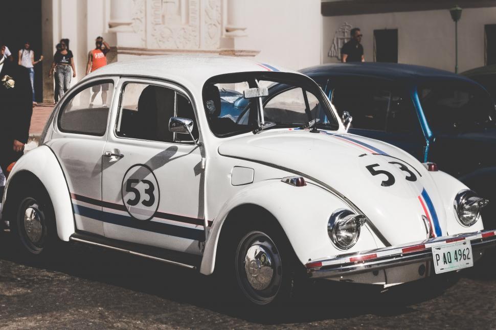 Free Image of White Car With Numbers Painted on Side 