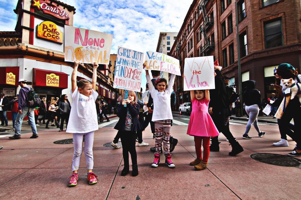 Free Image of Group of People Holding Signs on City Street 