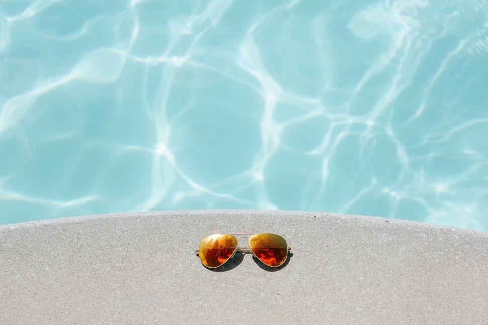 Free Image of Pair of Orange Flip Flops by Pool Edge 