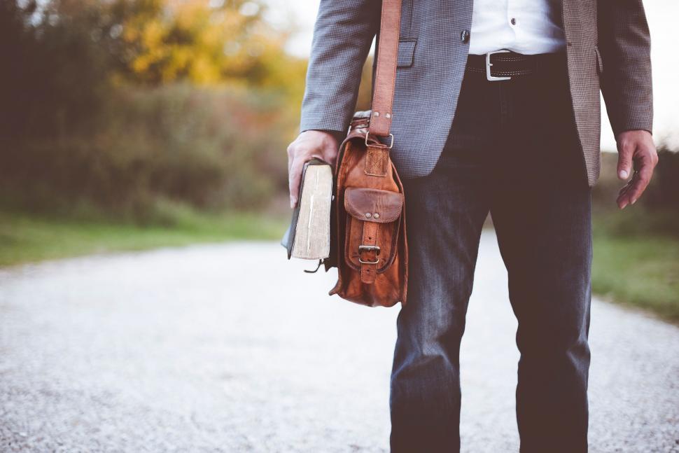 Free Image of Man in Suit and Tie Walking Down Road 