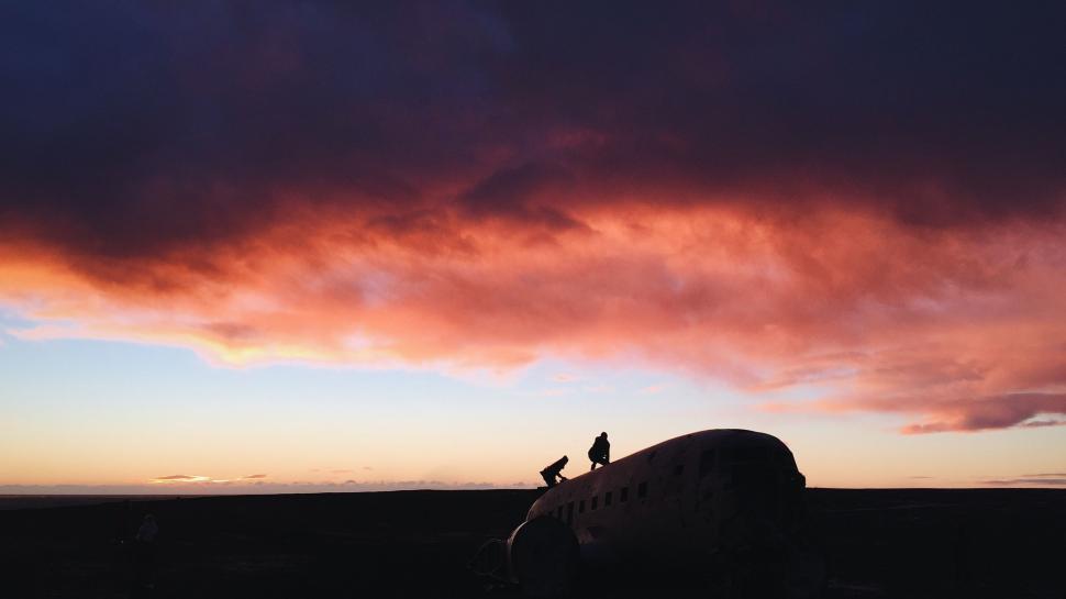 Free Image of People Standing on Top of an Airplane 