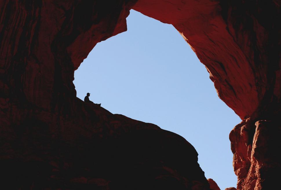 Free Image of Person Standing on Top of Rock Formation 