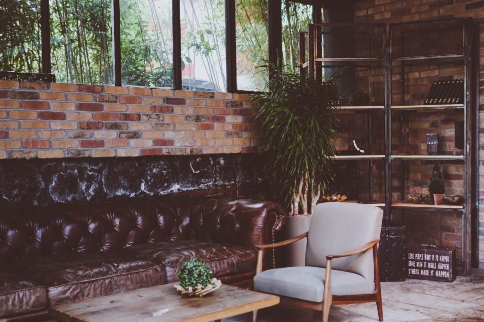 Free Image of A Living Room With Furniture and Brick Wall 