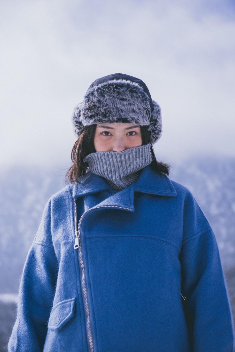 Free Image of Woman Wearing Blue Coat and Gray Hat 