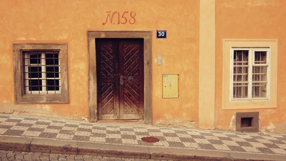 Free Image of Yellow Building With Black and White Checkered Floor 
