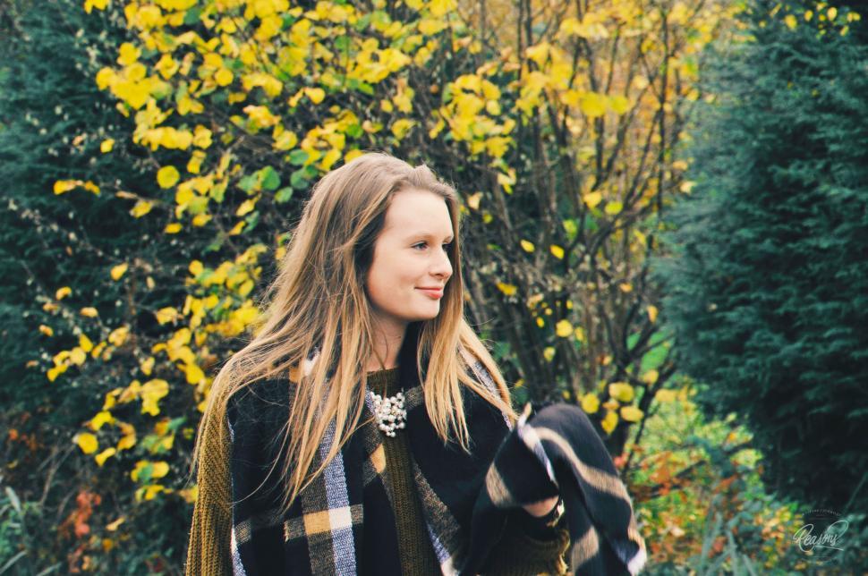 Free Image of Woman Standing in Front of Trees 