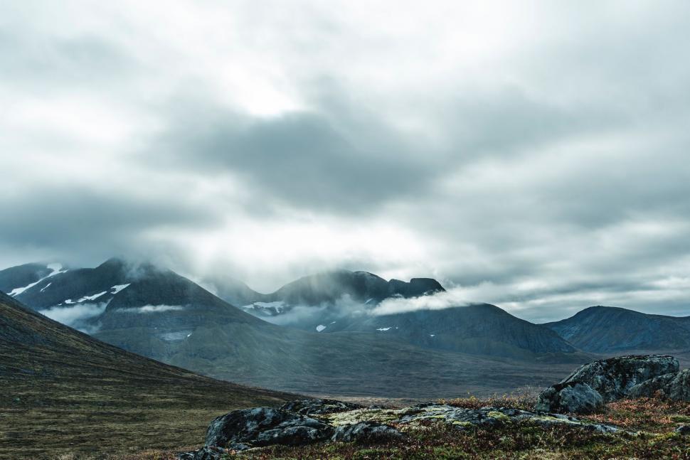 Free Image of Grassy Field With Mountain Range 