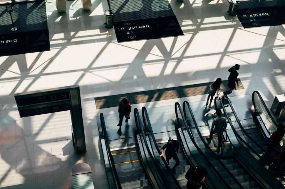 Free Image of Group of People Riding Bikes Down Escalator 