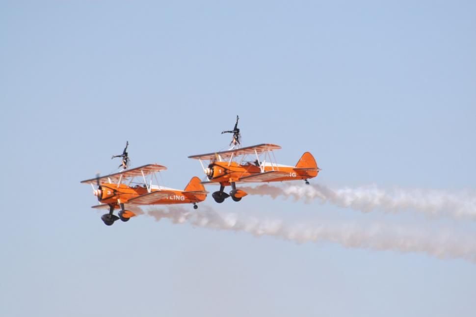 Free Image of Two Airplanes Flying in the Sky With Smoke Trails 