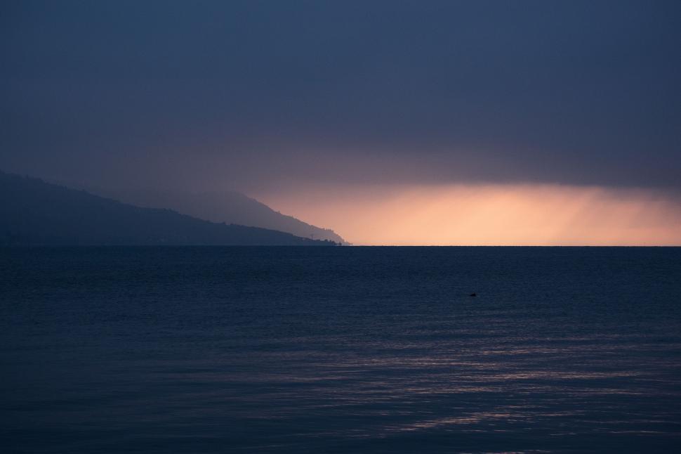 Free Image of Large Body of Water Under Cloudy Sky 