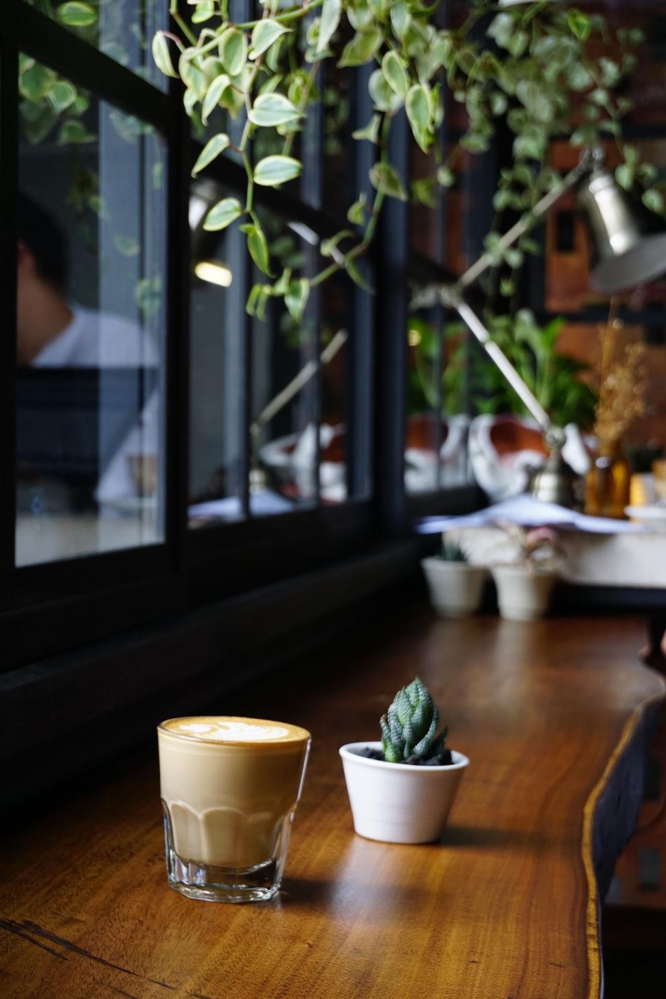Free Image of A Cup of Coffee on Wooden Table 