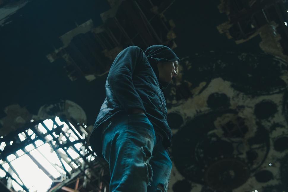 Free Image of Man in Hoodie Standing in Room 
