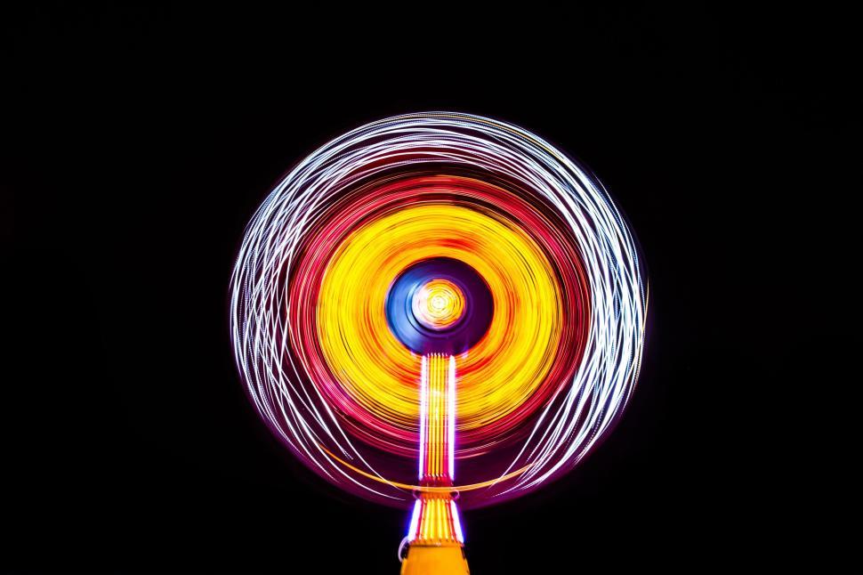 Free Image of Ferris Wheel Spinning in the Dark at Night 
