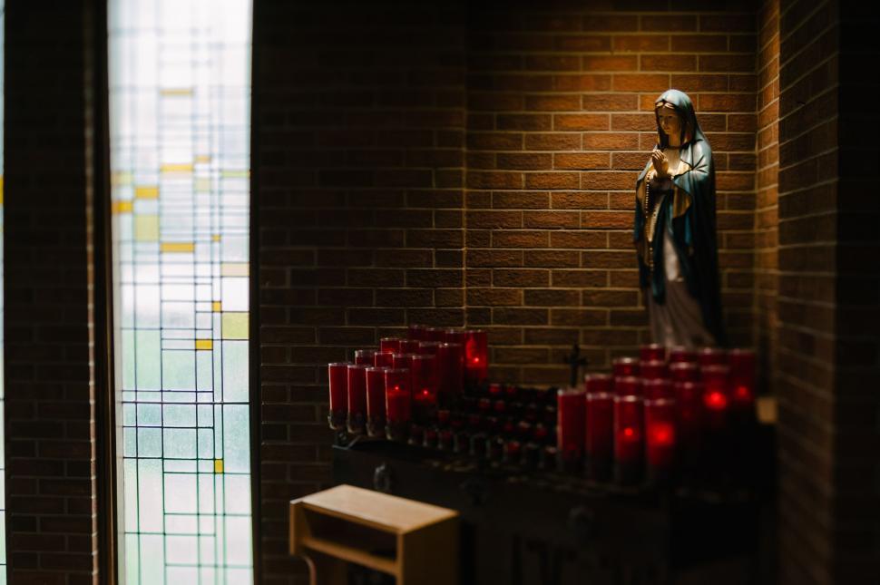 Free Image of Woman Standing Among Candles in Room 