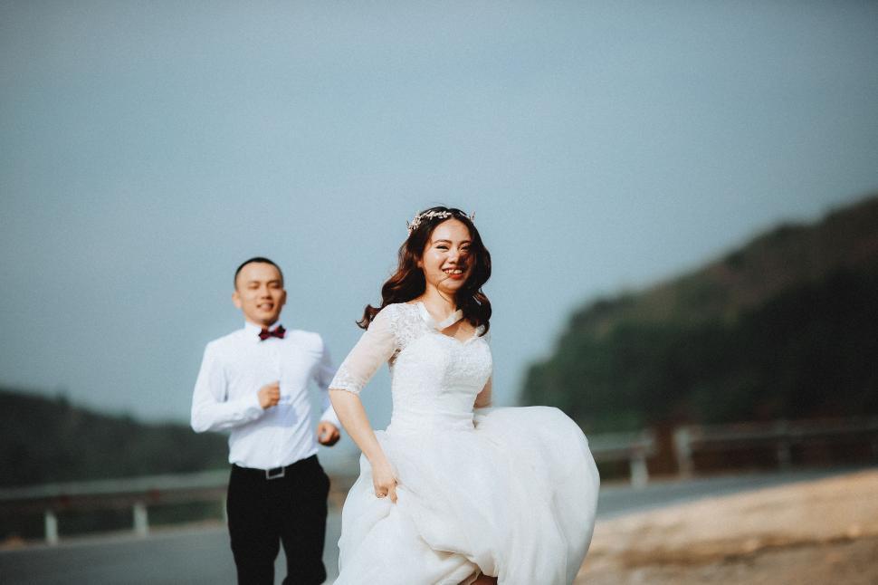Free Image of A Man and a Woman in Wedding Attire 