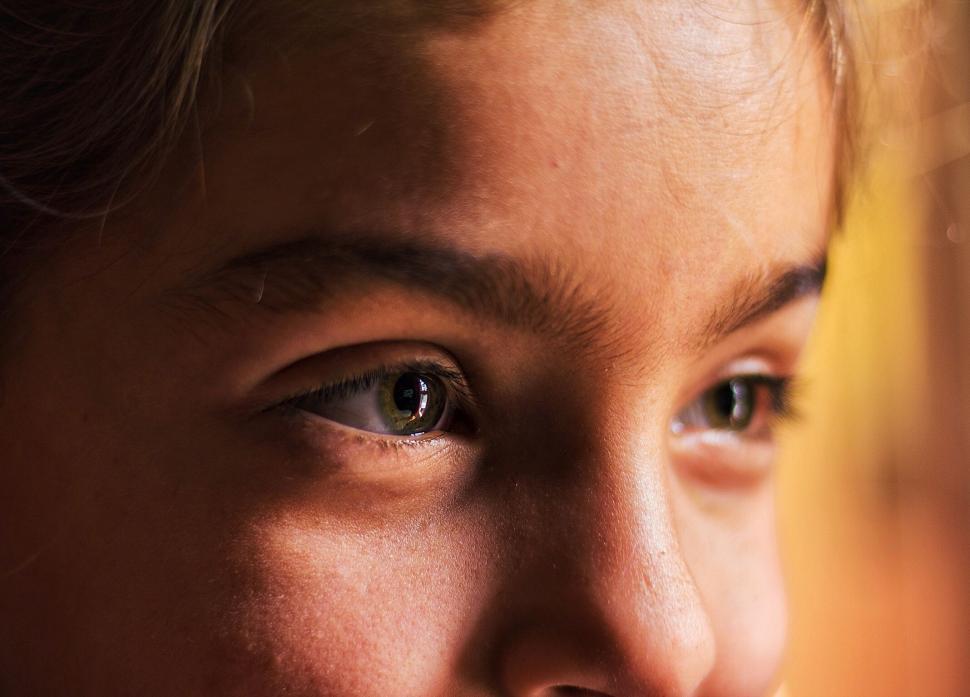Free Image of Persons Face Close Up With Banana in Background 