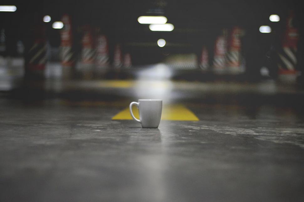 Free Image of Coffee Cup Abandoned in Parking Lot 