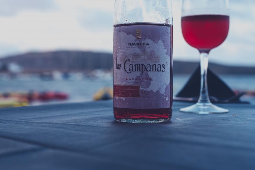 Free Image of Bottle of Wine and Glass of Wine on Table 