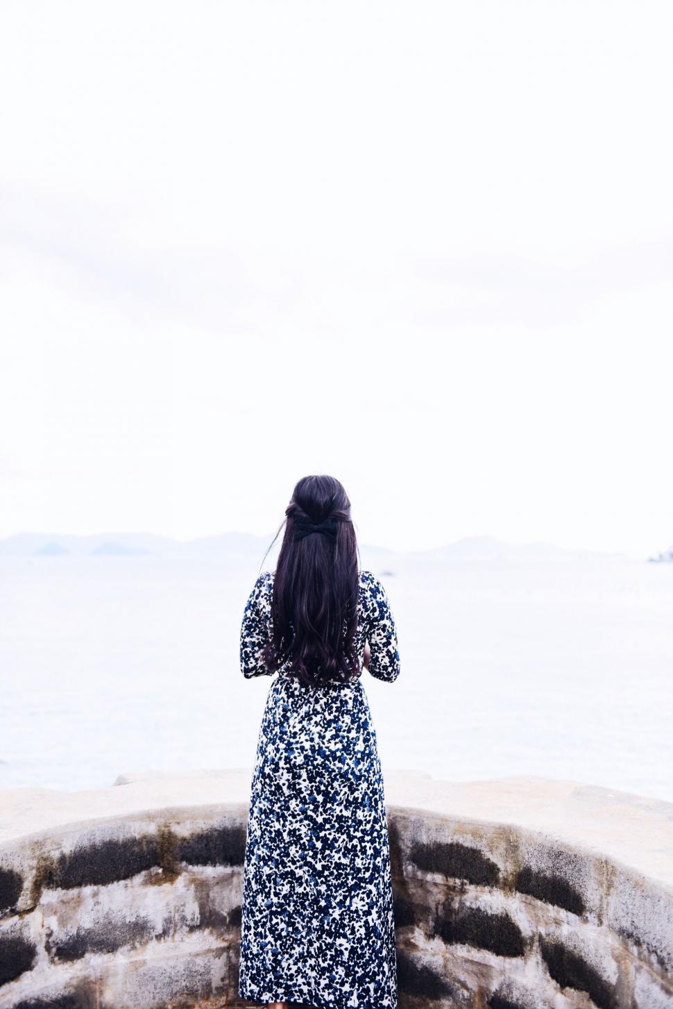 Free Image of Woman Standing on Top of Sandy Beach 