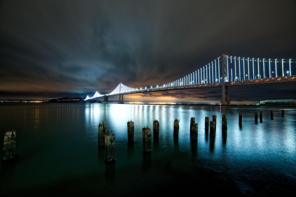 Free Image of Large Bridge Over Body of Water at Night 