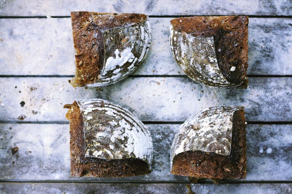 Free Image of Four Pieces of Bread on Wooden Table 