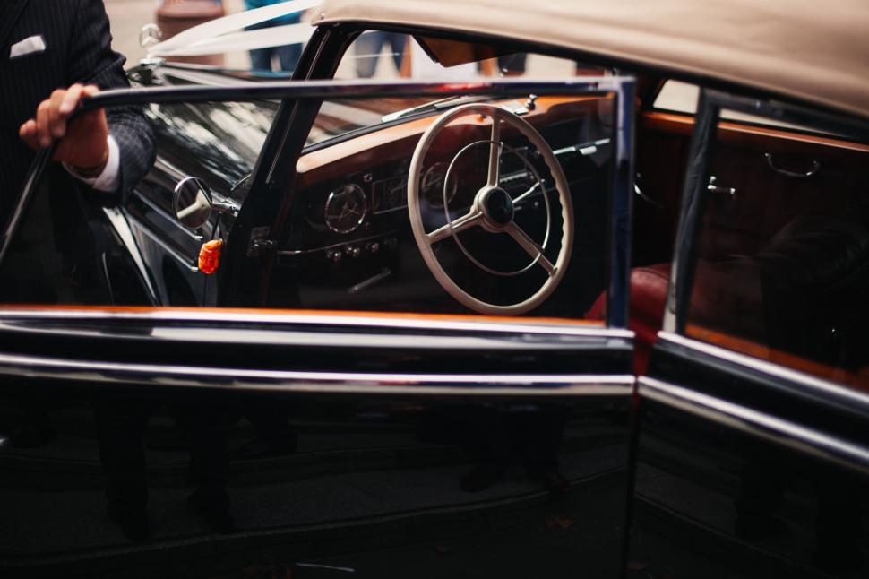Free Image of Man in Suit Holding Steering Wheel 