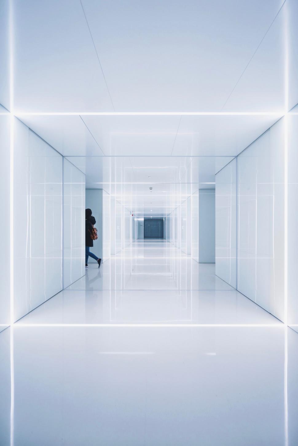 Free Image of Person Sitting in a Room With White Walls 