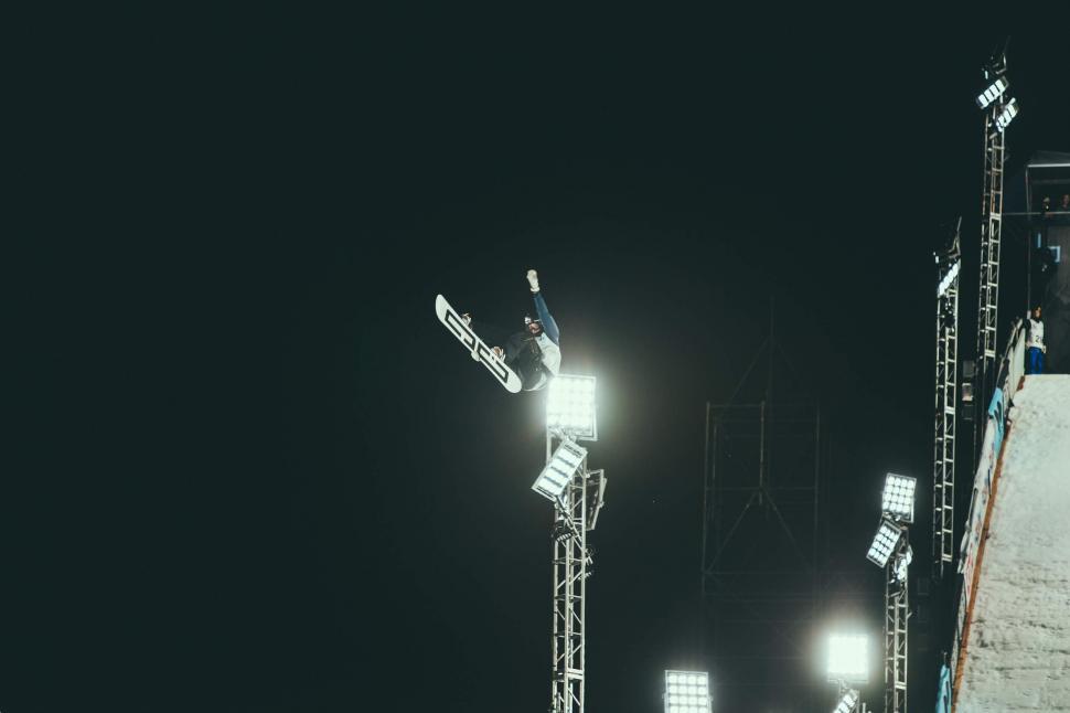 Free Image of Man Flying Through the Air on Snowboard 