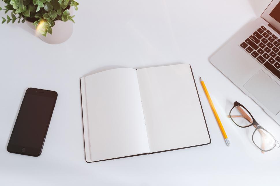 Free Image of Open Notebook, Pen, Eyeglasses, and Laptop on Desk 