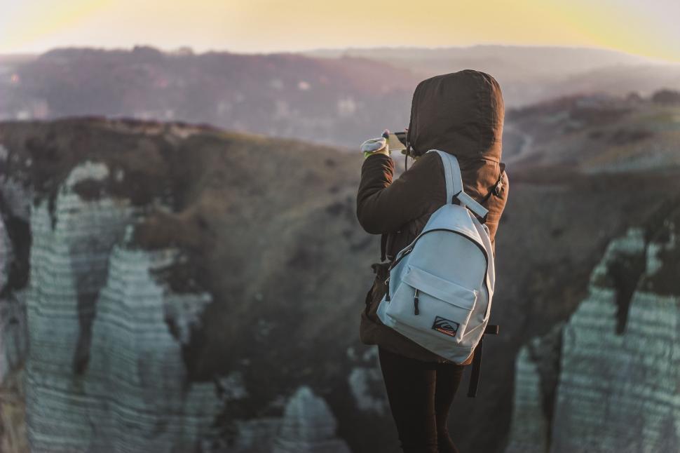 Free Image of Person With Backpack Taking Picture 