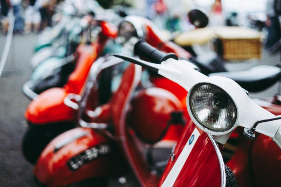 Free Image of Row of Red and White Scooters Parked Next to Each Other 