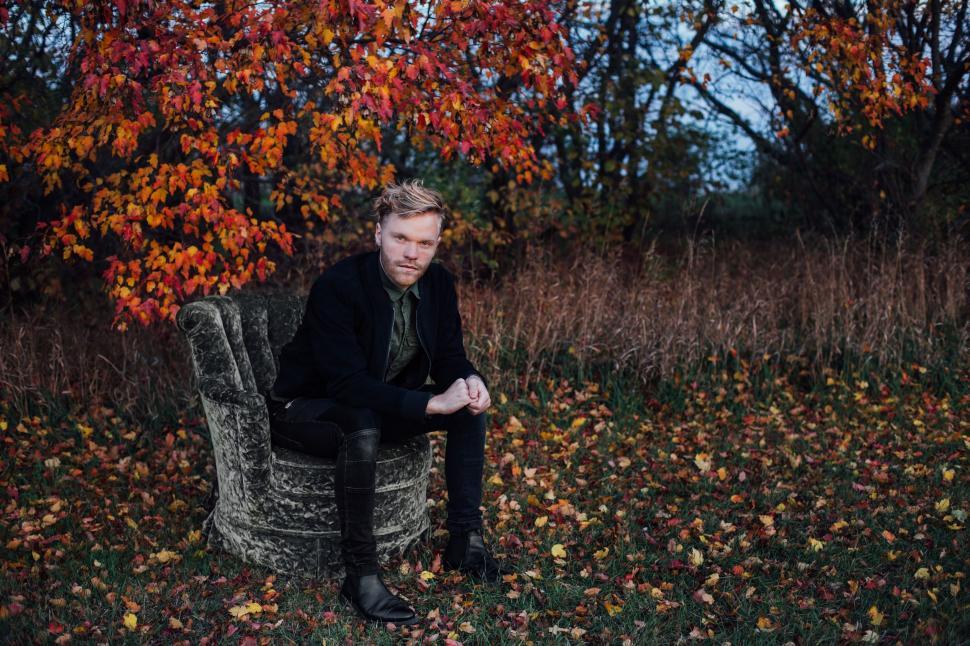 Free Image of Man Sitting on Top of Chair in Field 