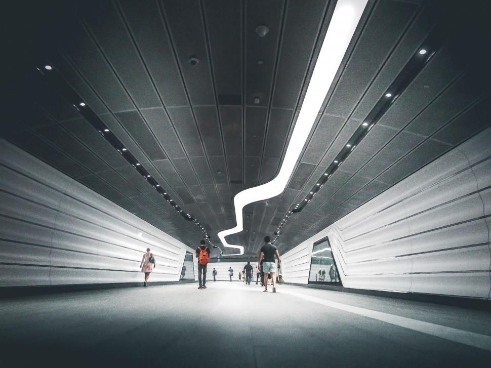 Free Image of People Walking Through Tunnel 