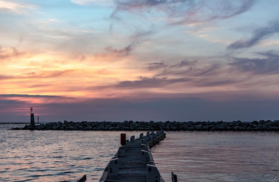 Free Image of Long Dock Extending Over Body of Water 
