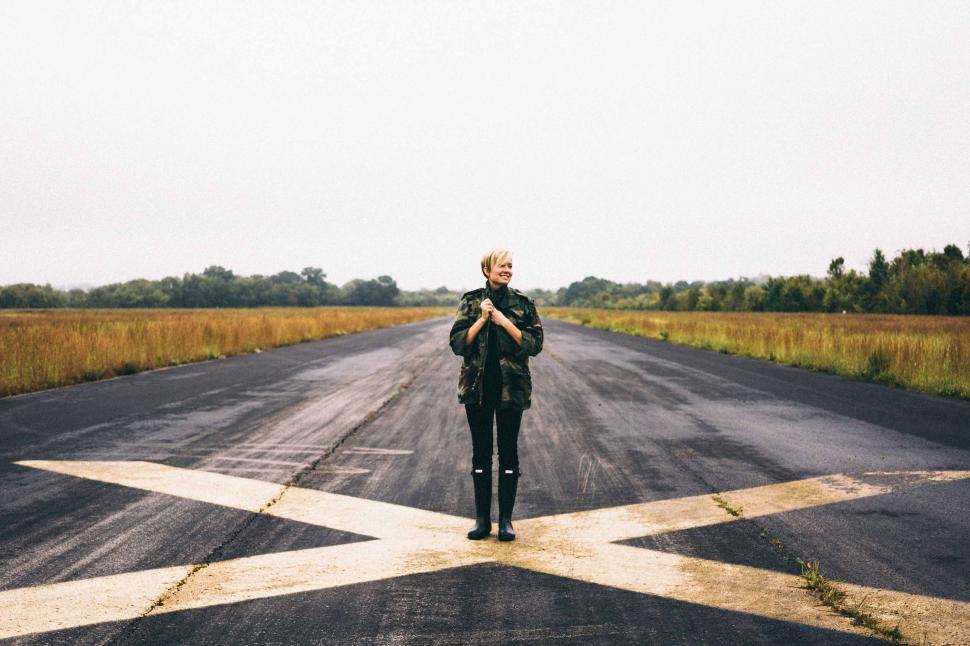 Free Image of Person Standing in the Middle of an Empty Road 