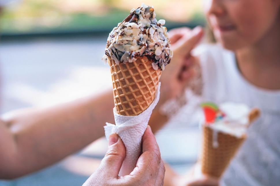 Free Image of Woman Holding Ice Cream Cone 