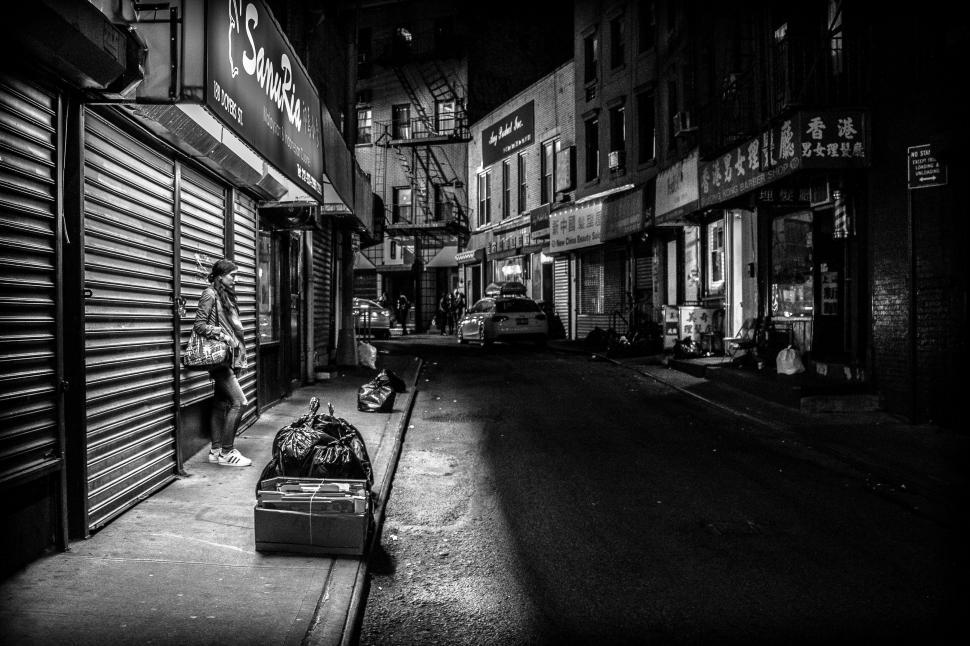 Free Image of Person Standing on Street Corner With Suitcase 