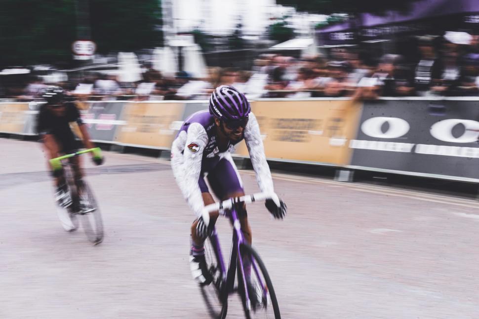 Free Image of Blurry Photo of Two Bicyclists Riding Down a Street 