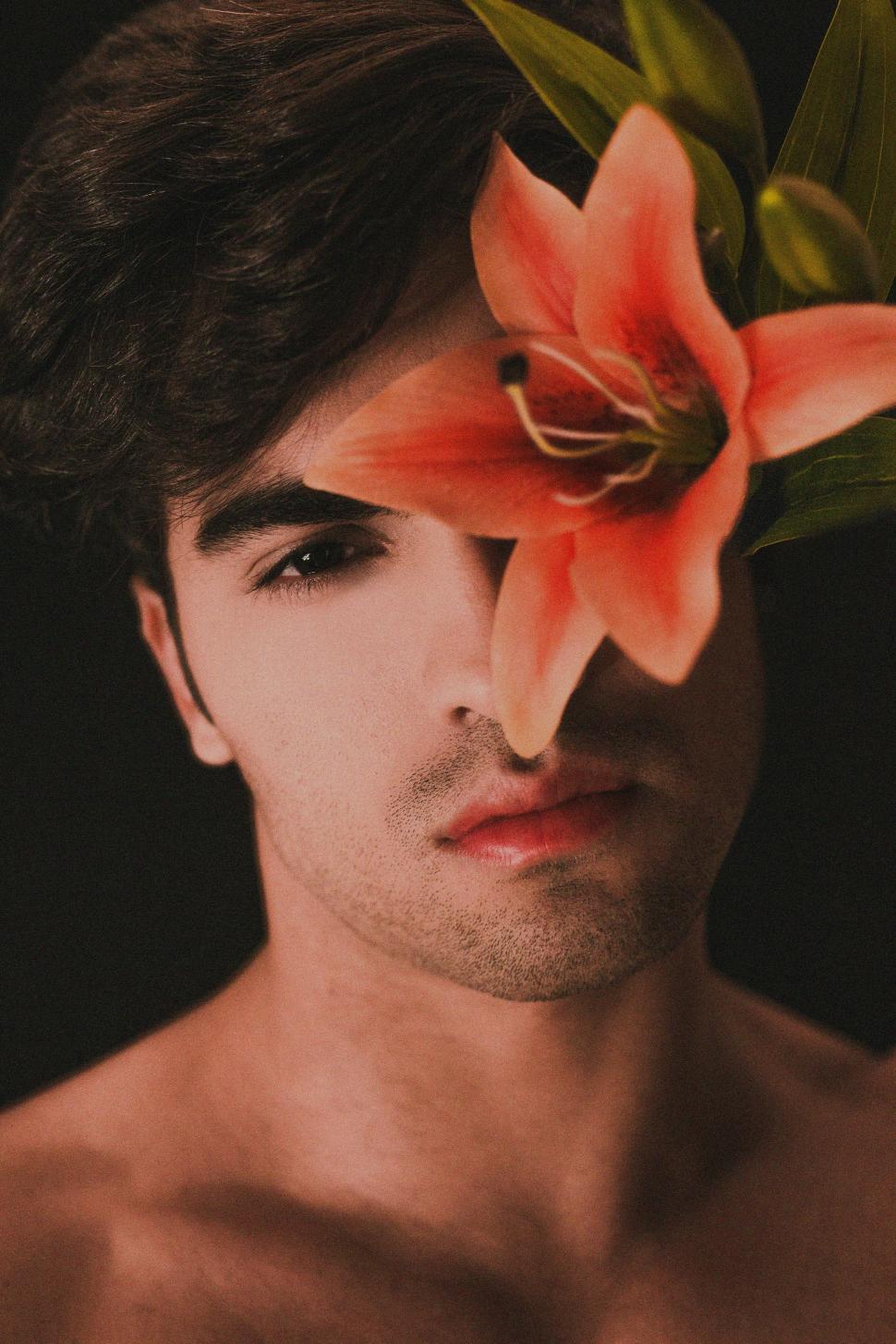 Free Image of Man Wearing Flower in Hair 